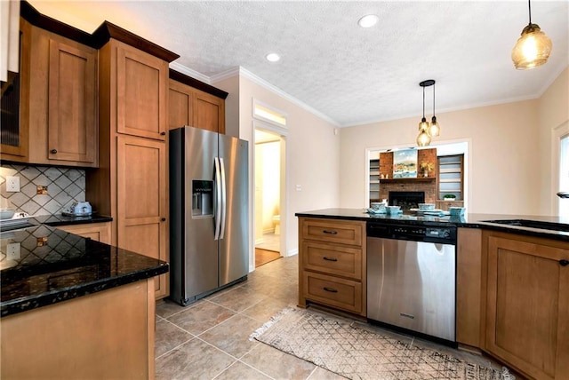 kitchen with hanging light fixtures, crown molding, sink, and appliances with stainless steel finishes