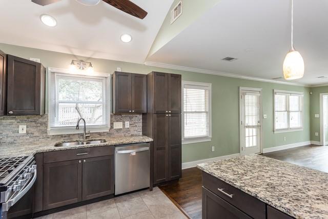 kitchen with dark brown cabinets, visible vents, appliances with stainless steel finishes, and a sink