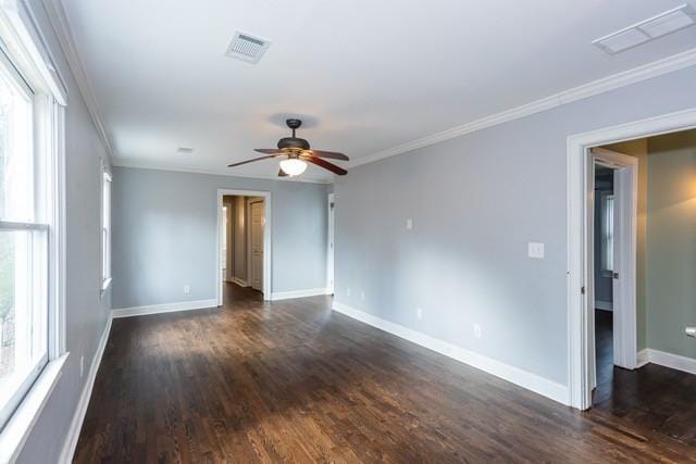 unfurnished room with visible vents, baseboards, and ornamental molding