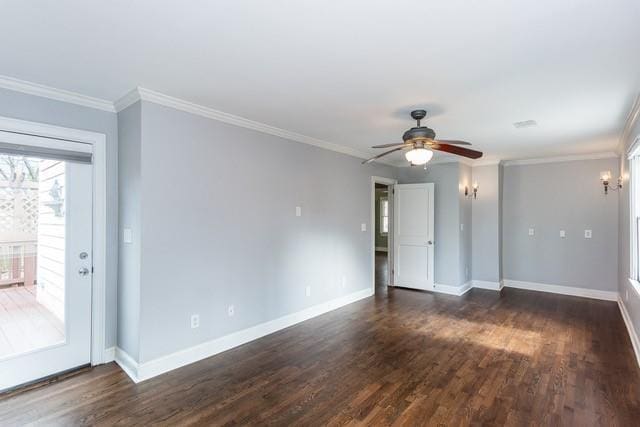 empty room with crown molding, a ceiling fan, dark wood-type flooring, and baseboards