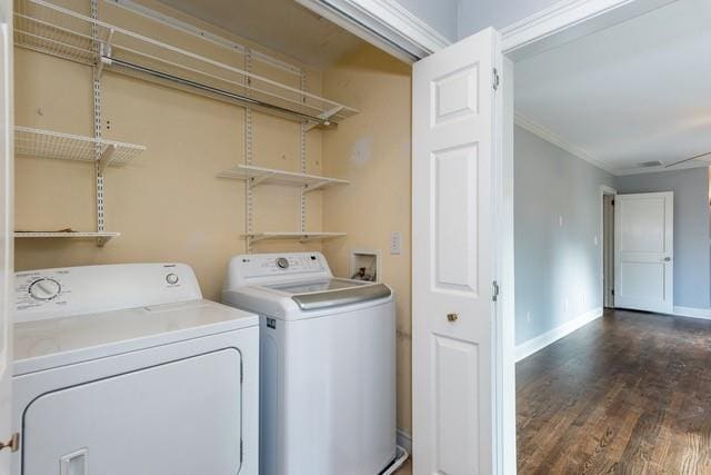 laundry room featuring baseboards, separate washer and dryer, ornamental molding, and laundry area