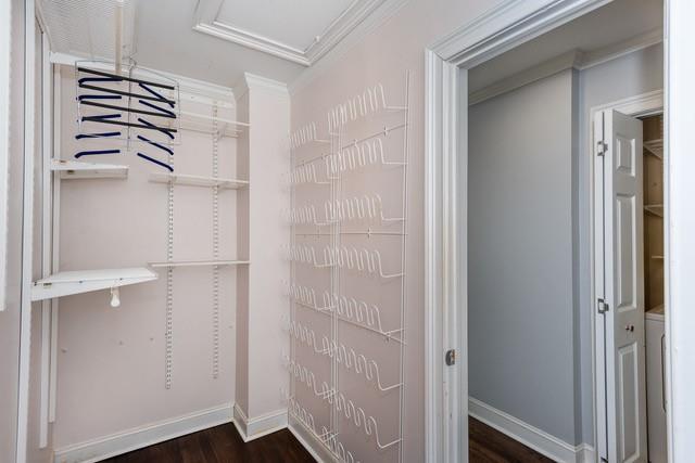 spacious closet with dark wood-style floors