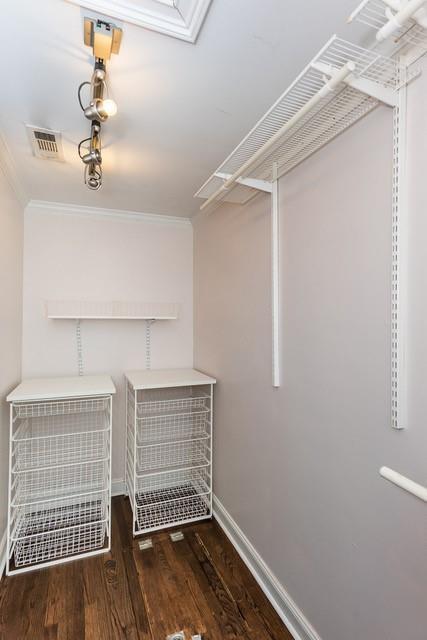 walk in closet with wood finished floors and visible vents