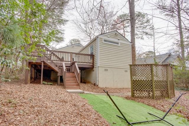 rear view of property with stairway and a wooden deck