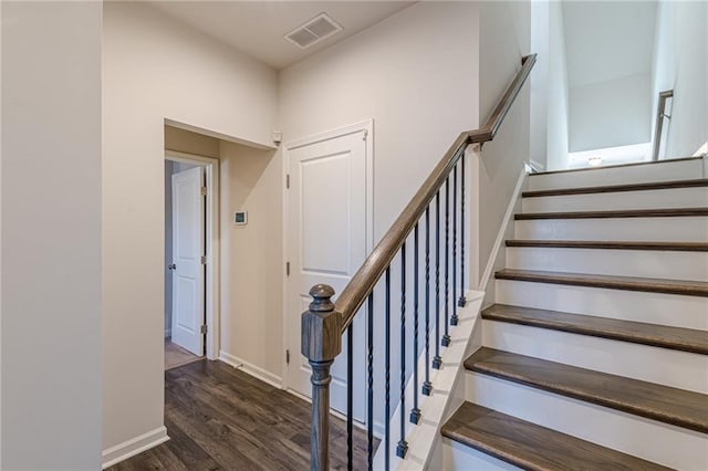 stairs featuring hardwood / wood-style flooring