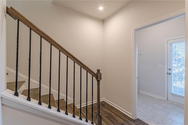 stairway featuring tile patterned flooring