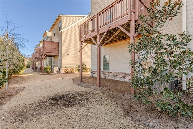 view of home's exterior with a wooden deck