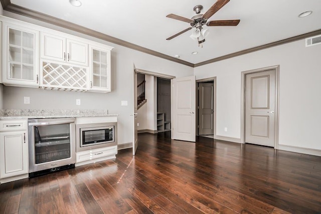 1435 Druid Mnr, Atlanta, GA 30329 - unfurnished living room with beverage cooler, ornamental molding, a ceiling fan, dark wood finished floors, and baseboards