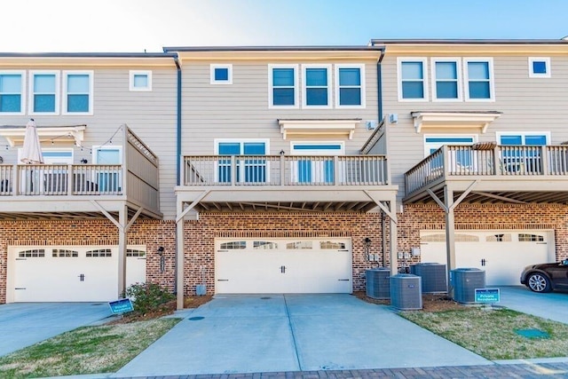 1435 Druid Mnr, Atlanta, GA 30329 - back of house featuring central AC unit, an attached garage, and brick siding