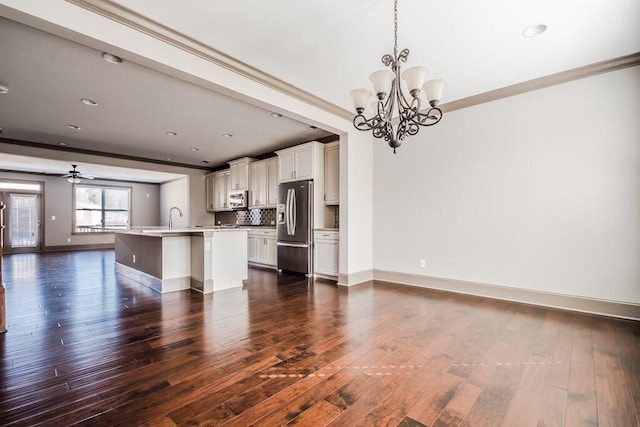 1435 Druid Mnr, Atlanta, GA 30329 - unfurnished living room featuring ornamental molding, baseboards, a chandelier, a sink, and dark wood-type flooring