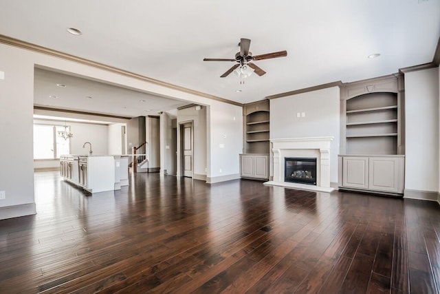 1435 Druid Mnr, Atlanta, GA 30329 - unfurnished living room featuring ceiling fan, dark wood-type flooring, a glass covered fireplace, baseboards, and ornamental molding