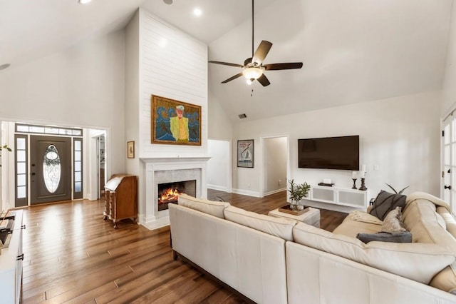 living room with ceiling fan, wood-type flooring, and high vaulted ceiling