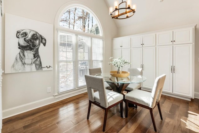 dining space featuring an inviting chandelier, high vaulted ceiling, and dark hardwood / wood-style floors