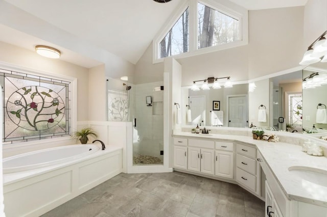 bathroom featuring plus walk in shower, a healthy amount of sunlight, vanity, and high vaulted ceiling