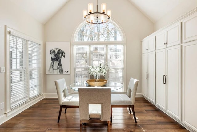 dining space featuring dark hardwood / wood-style flooring, a notable chandelier, and high vaulted ceiling