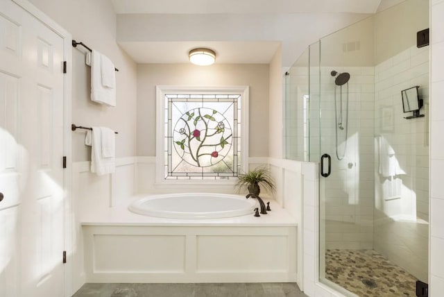 bathroom featuring separate shower and tub