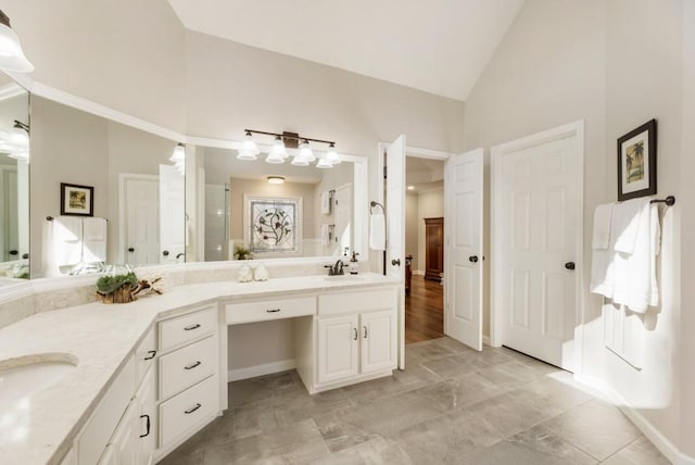 bathroom with vanity and high vaulted ceiling