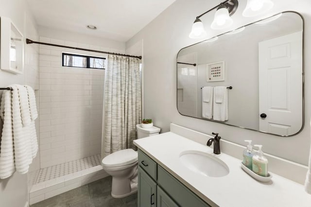 bathroom with vanity, curtained shower, and toilet