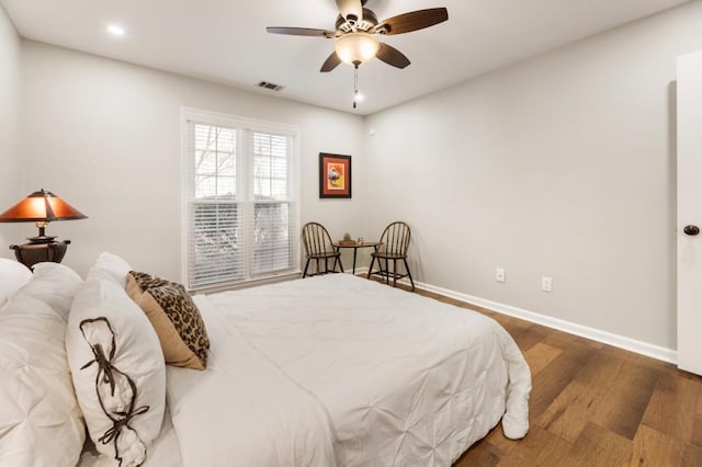 bedroom with ceiling fan and dark hardwood / wood-style flooring