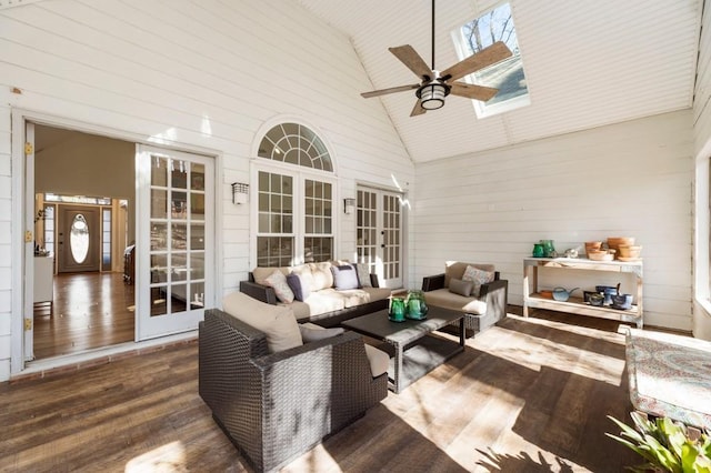 interior space with vaulted ceiling with skylight and ceiling fan