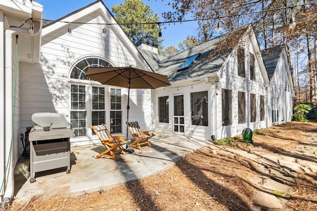 rear view of property featuring a patio area