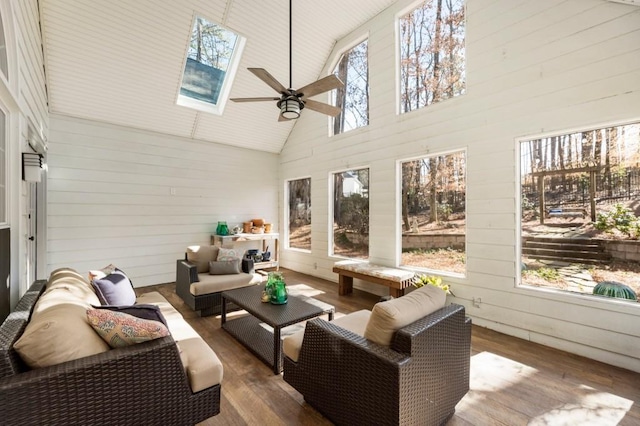 sunroom / solarium with ceiling fan, a healthy amount of sunlight, and lofted ceiling with skylight