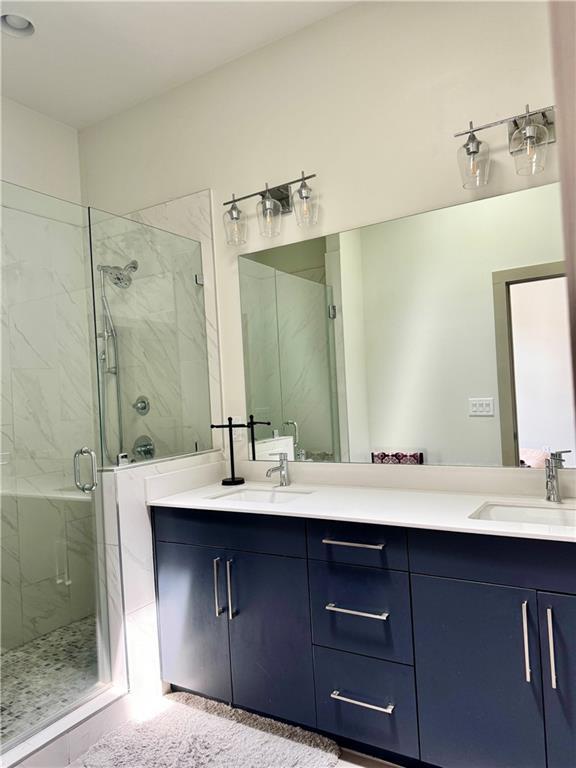 1153 Reynolds Square Ln # 16, Atlanta, GA 30307 - full bathroom with a marble finish shower and double vanity
