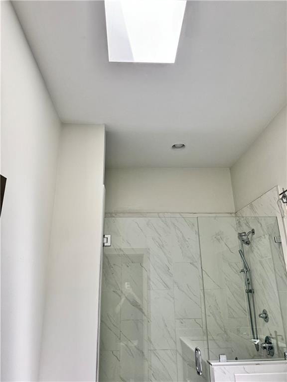 1153 Reynolds Square Ln # 16, Atlanta, GA 30307 - bathroom featuring a marble finish shower and a skylight
