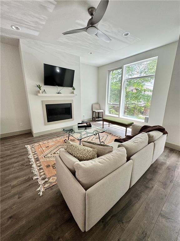 1153 Reynolds Square Ln # 16, Atlanta, GA 30307 - living room featuring baseboards, wood finished floors, a fireplace, a ceiling fan, and recessed lighting