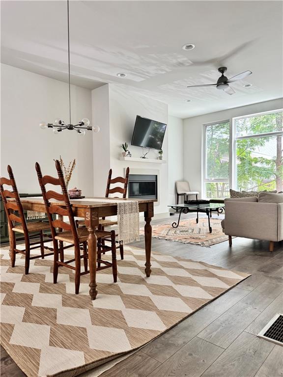 1153 Reynolds Square Ln # 16, Atlanta, GA 30307 - dining space featuring light wood-style floors, recessed lighting, a glass covered fireplace, and a ceiling fan