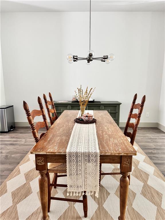 1153 Reynolds Square Ln # 16, Atlanta, GA 30307 - dining room with light wood finished floors, baseboards, and a chandelier
