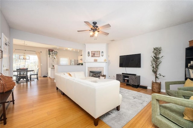 living room featuring light hardwood / wood-style floors and ceiling fan