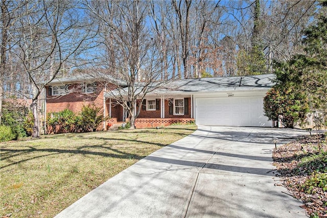 split level home featuring a front yard, brick siding, driveway, and an attached garage