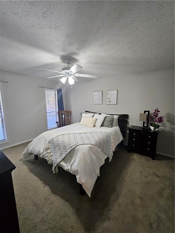 carpeted bedroom featuring baseboards, a textured ceiling, and a ceiling fan