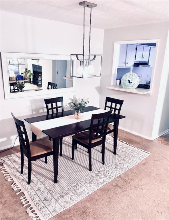 1507 Wynnes Ridge Cir SE, Marietta, GA 30067 - carpeted dining area with a chandelier and baseboards
