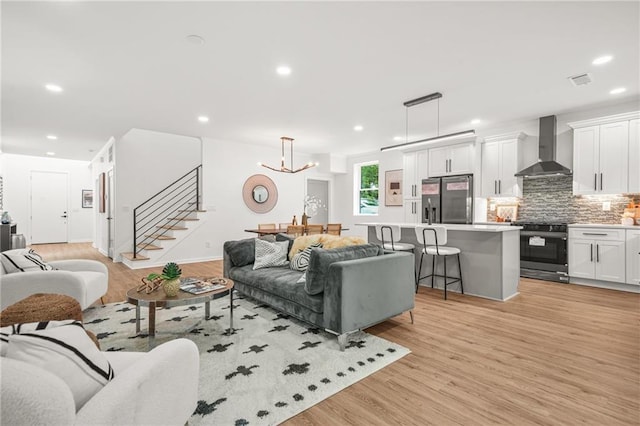 2926 5th St SW, Atlanta, GA 30315 - living room with stairs, recessed lighting, light wood-style floors, and a chandelier