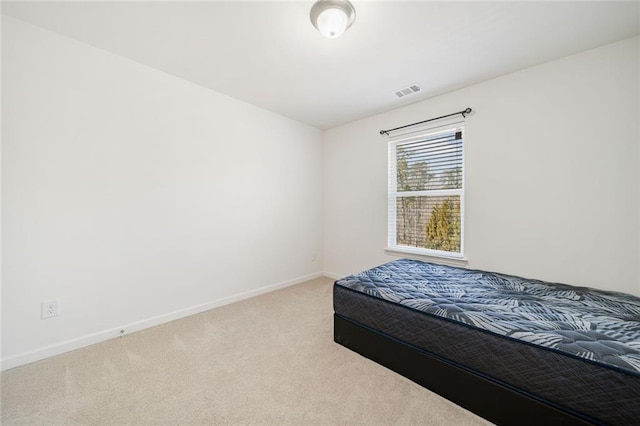 carpeted bedroom featuring visible vents and baseboards