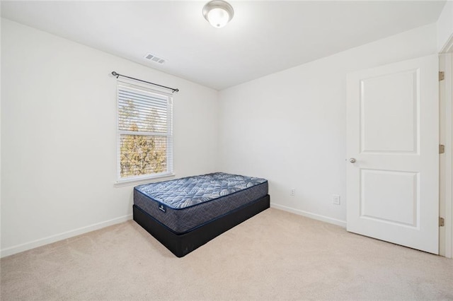 bedroom featuring carpet floors, visible vents, and baseboards