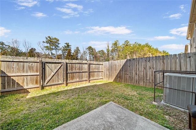 view of yard with central air condition unit and a fenced backyard