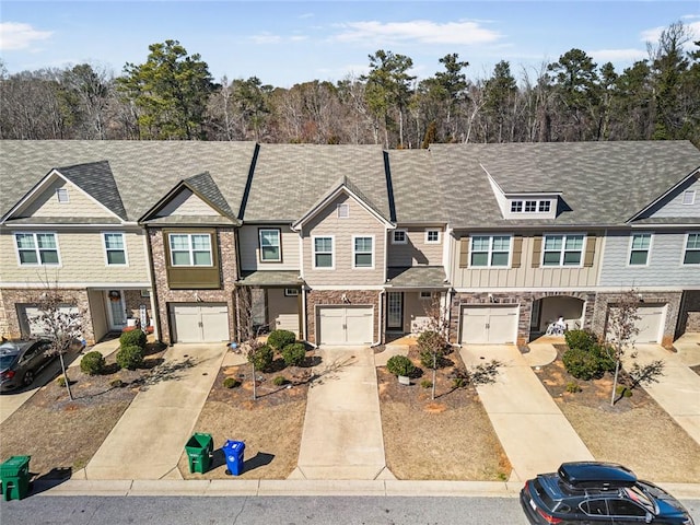 townhome / multi-family property featuring driveway, a garage, and board and batten siding