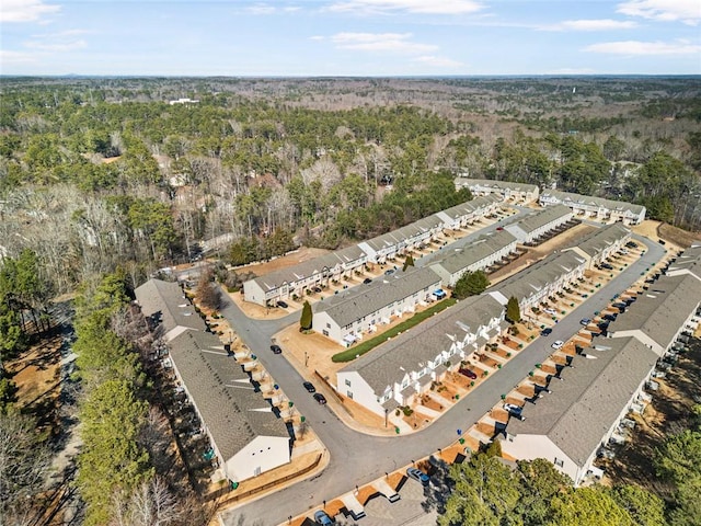 drone / aerial view featuring a wooded view