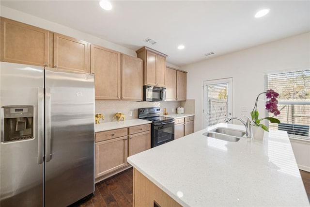 kitchen featuring dark wood-style flooring, visible vents, black range with electric stovetop, a sink, and stainless steel fridge