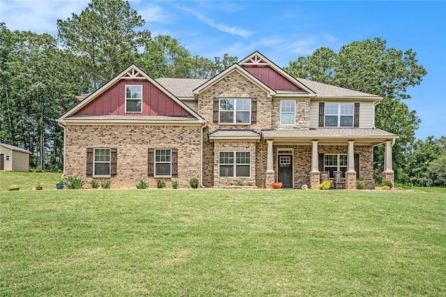 381 Homestead Cir, Forsyth, GA 31029 - craftsman-style house with a front lawn, board and batten siding, a porch, and brick siding