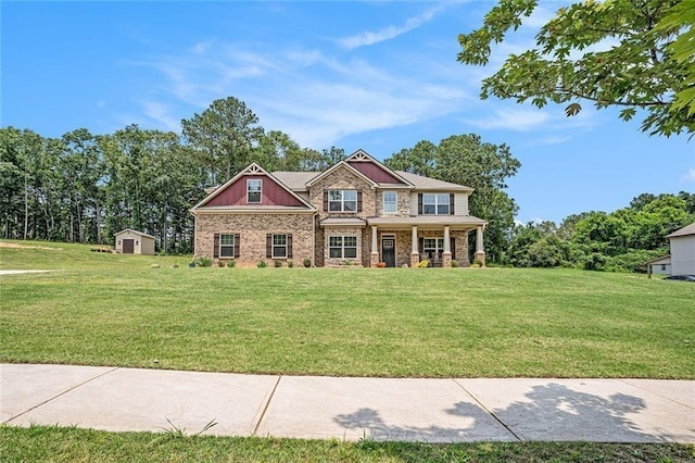 381 Homestead Cir, Forsyth, GA 31029 - craftsman-style home with a porch, a front yard, a storage unit, and stone siding