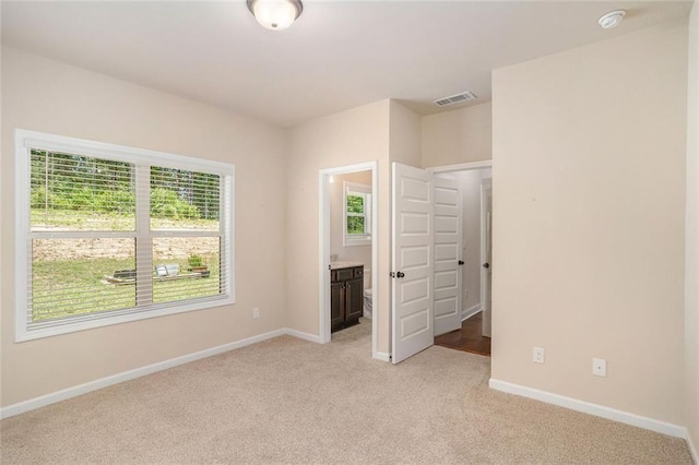 381 Homestead Cir, Forsyth, GA 31029 - unfurnished bedroom featuring light colored carpet and ensuite bathroom