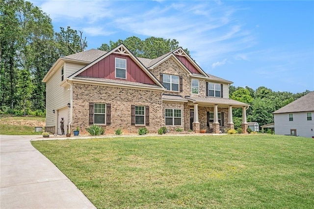 381 Homestead Cir, Forsyth, GA 31029 - craftsman house featuring board and batten siding, a porch, an attached garage, a front lawn, and concrete driveway