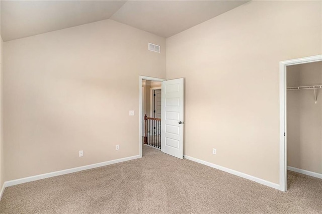 381 Homestead Cir, Forsyth, GA 31029 - unfurnished bedroom featuring a walk in closet, carpet, a closet, and high vaulted ceiling