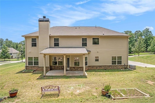 381 Homestead Cir, Forsyth, GA 31029 - back of house featuring a patio, a chimney, a yard, and a vegetable garden