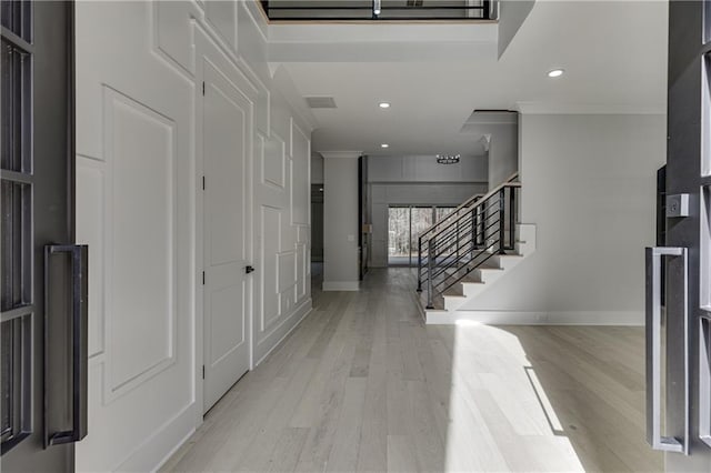 foyer entrance with light wood-type flooring