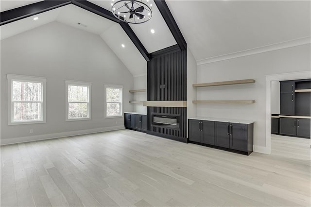 unfurnished living room featuring an inviting chandelier, high vaulted ceiling, light hardwood / wood-style floors, and beamed ceiling